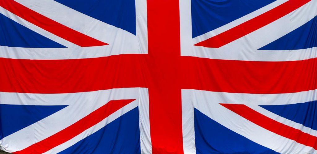 Union Jack flag draped over a historic stone wall, symbolizing British heritage in Rochester, England.
